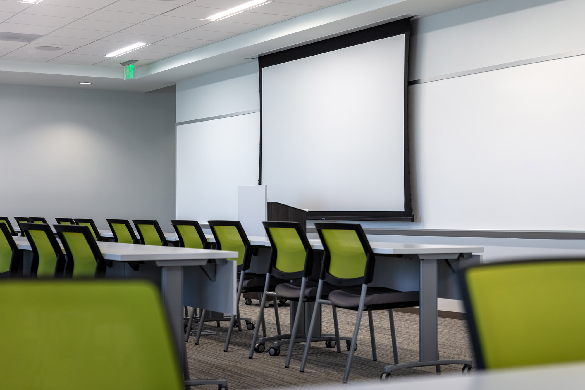 Large, modern conference room with a large TV and projector