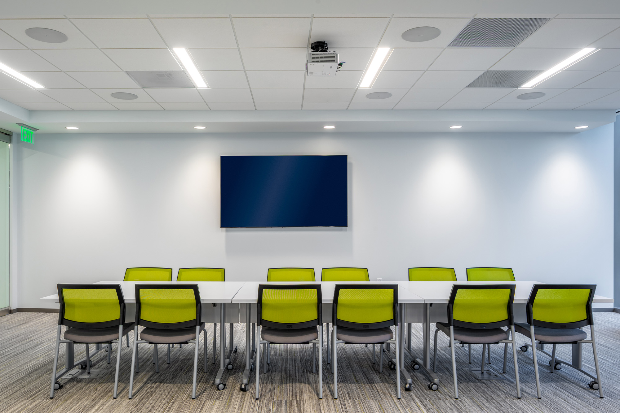 Clean, modern conference room with a large TV